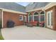 Outdoor patio featuring comfortable furniture and a grill with brick exterior at 718 First Cotton Dr, Powder Springs, GA 30127