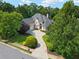 Aerial view of the home showing the long driveway, mature trees, and landscaping around the property at 9745 Autry Falls Dr, Alpharetta, GA 30022