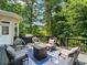 Relaxing back deck area with outdoor seating and a serene view of the surrounding trees at 9745 Autry Falls Dr, Alpharetta, GA 30022