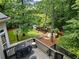 Expansive backyard with a basketball hoop, lush greenery, and a patio area, ideal for outdoor activities at 9745 Autry Falls Dr, Alpharetta, GA 30022