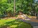 Lush backyard featuring a custom built playset and a rock waterfall, perfect for Gathering fun at 9745 Autry Falls Dr, Alpharetta, GA 30022