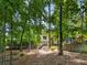 Beautiful backyard with custom landscaping, stone accents, and a view of the home at 9745 Autry Falls Dr, Alpharetta, GA 30022