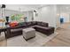 Spacious finished basement with a comfortable sectional sofa, plush ottoman, and neutral area rug at 9745 Autry Falls Dr, Alpharetta, GA 30022