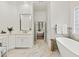 Luxurious bathroom featuring a soaking tub, marble countertops, and elegant fixtures at 9745 Autry Falls Dr, Alpharetta, GA 30022