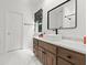 Bathroom featuring a modern vanity with a sleek sink, a large mirror, and stylish fixtures at 9745 Autry Falls Dr, Alpharetta, GA 30022