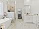 Spacious bathroom features marble floors, soaking tub, glass enclosed shower, and walk-in closet at 9745 Autry Falls Dr, Alpharetta, GA 30022