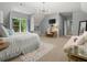 Spacious bedroom with a sitting area, a desk, and a cozy atmosphere at 9745 Autry Falls Dr, Alpharetta, GA 30022