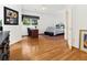 Bright bedroom featuring hardwood floors, a ceiling fan, and a cozy sleeping space with a work area at 9745 Autry Falls Dr, Alpharetta, GA 30022