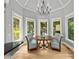 Charming breakfast nook features a round table, patterned chairs, and lots of windows at 9745 Autry Falls Dr, Alpharetta, GA 30022