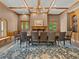 A beautiful dining room with wood trim, chandelier, and large table and chairs at 9745 Autry Falls Dr, Alpharetta, GA 30022