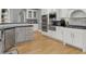 A well-equipped kitchen with stainless steel appliances and classic white cabinetry and backsplash at 9745 Autry Falls Dr, Alpharetta, GA 30022