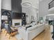 Open-concept living room boasts a fireplace, built-in shelving, and views into other living spaces at 9745 Autry Falls Dr, Alpharetta, GA 30022