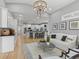 An open floor plan showing the living room and kitchen features modern decor and hardwood flooring throughout at 9745 Autry Falls Dr, Alpharetta, GA 30022