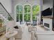 Sun-drenched living room with fireplace, custom built-ins, and large windows showcasing the wooded property at 9745 Autry Falls Dr, Alpharetta, GA 30022