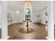 Clubhouse lobby with wood floors, columns, round table, and chandelier at 9745 Autry Falls Dr, Alpharetta, GA 30022