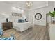 Bright and airy main bedroom features wood-look flooring, tray ceiling, and a modern chandelier at 9745 Autry Falls Dr, Alpharetta, GA 30022