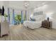 Serene main bedroom suite with hardwood floors, tray ceiling, and large windows at 9745 Autry Falls Dr, Alpharetta, GA 30022