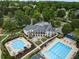 Aerial view of a community clubhouse featuring an outdoor pool area, patio, and lush landscaping at 9745 Autry Falls Dr, Alpharetta, GA 30022