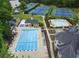 Aerial view of community pools, clubhouse, playground, and tennis courts surrounded by mature trees at 9745 Autry Falls Dr, Alpharetta, GA 30022