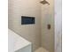 Modern shower with white subway tile, gold fixtures and a blue-tiled niche at 9745 Autry Falls Dr, Alpharetta, GA 30022