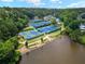 Aerial view of the tennis courts near the lake, all beautifully kept, with lush green landscaping at 9745 Autry Falls Dr, Alpharetta, GA 30022