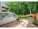 Landscaped backyard with stone pathway and a wooded backdrop at 1290 Magnolia Park Cir, Cumming, GA 30040