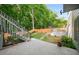 Serene backyard view with a stone patio and lush landscaping at 1290 Magnolia Park Cir, Cumming, GA 30040
