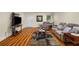 Basement living room showcasing laminate flooring, a recliner sofa, TV and a geometric rug at 1290 Magnolia Park Cir, Cumming, GA 30040
