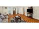 Basement living room with neutral colored walls, a decorative mirror and laminate hardwood floors at 1290 Magnolia Park Cir, Cumming, GA 30040