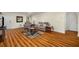 Basement living room showcasing hardwood laminate floor, recliner sofas, TV and access to other rooms at 1290 Magnolia Park Cir, Cumming, GA 30040