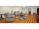 Basement living room with recliner sofa set, ceiling fan, accent rug, and wood laminate flooring at 1290 Magnolia Park Cir, Cumming, GA 30040