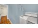 Upstairs bathroom with sink, custom shelving, ornate candle holders, walk-in closet and hardwood floors at 1290 Magnolia Park Cir, Cumming, GA 30040