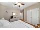 This bedroom features hardwood floors, ceiling fan, dresser, and closet at 1290 Magnolia Park Cir, Cumming, GA 30040
