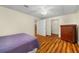 Bright bedroom with a wood floor, closet, and white door at 1290 Magnolia Park Cir, Cumming, GA 30040