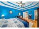 Bedroom featuring vibrant blue walls, hardwood floors, and full bathroom at 1290 Magnolia Park Cir, Cumming, GA 30040