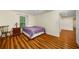 This bedroom has a wood floor, a window, and a view to an adjacent hallway at 1290 Magnolia Park Cir, Cumming, GA 30040