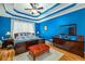Primary bedroom with blue walls and decorative tray ceiling at 1290 Magnolia Park Cir, Cumming, GA 30040