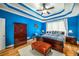 Bright Primary bedroom with blue walls and a tray ceiling at 1290 Magnolia Park Cir, Cumming, GA 30040