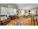 Bright dining area with hardwood floors, a large window, and seamless access to the kitchen and living spaces at 1290 Magnolia Park Cir, Cumming, GA 30040