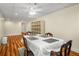 Well-lit dining area with wood floors, shelving, and a vintage table setting at 1290 Magnolia Park Cir, Cumming, GA 30040