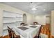 Bright dining area with ceiling fan, wood floors, and ample shelving space at 1290 Magnolia Park Cir, Cumming, GA 30040