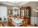 Formal dining area with a chandelier, hardwood floors, and custom built-in cabinetry at 1290 Magnolia Park Cir, Cumming, GA 30040