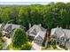 Aerial view of a two-story home with a manicured front lawn and mature trees at 1290 Magnolia Park Cir, Cumming, GA 30040