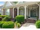 Inviting front porch with columns and lush landscaping, perfect for relaxing at 1290 Magnolia Park Cir, Cumming, GA 30040