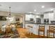 Modern kitchen featuring a breakfast bar, stainless steel appliances, and an open layout leading to the dining area at 1290 Magnolia Park Cir, Cumming, GA 30040