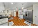 Bright eat-in kitchen with wood floors, stainless appliances, granite countertops and white cabinets at 1290 Magnolia Park Cir, Cumming, GA 30040