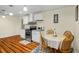 Bright eat-in kitchen with wood floors, stainless appliances, and white cabinets at 1290 Magnolia Park Cir, Cumming, GA 30040