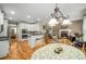 Eat-in kitchen featuring white cabinets, granite countertops, stainless steel appliances, and a cozy dining area at 1290 Magnolia Park Cir, Cumming, GA 30040