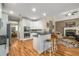 Bright kitchen with white cabinets, granite counters, and a breakfast bar, seamlessly connecting to the living space at 1290 Magnolia Park Cir, Cumming, GA 30040