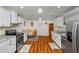 Charming eat-in kitchen with wood floors, stainless appliances, and granite countertops at 1290 Magnolia Park Cir, Cumming, GA 30040